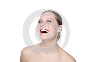 Young woman laughing out loud, over white background