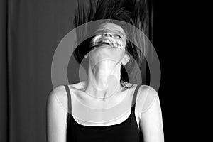 Young woman laughing and throwing her head back.