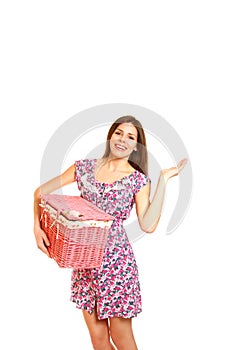 Young woman with a laundry basket on white background