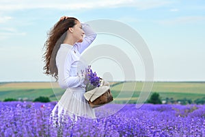 Young woman is in the lavender flower field, beautiful summer landscape