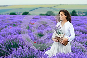 Young woman is in the lavender flower field, beautiful summer landscape