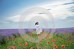 Young woman is in the lavender flower field, beautiful summer landscape