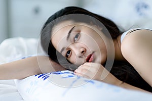 Young woman lay on a bed