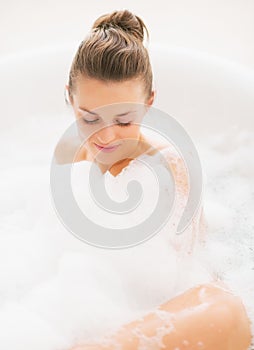 Young woman laying in bathtub