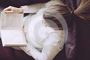 Young woman reading book at home