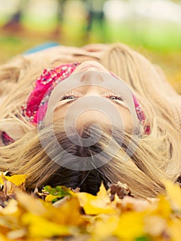Young woman laying down in autumn park