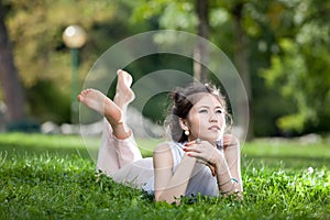 Young woman laying on grass