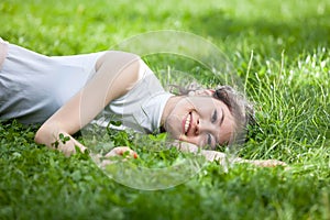 Young woman laying on grass