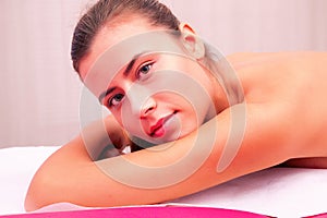 Young woman laying on massage bed