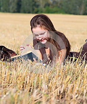 Young woman lays on yellow field