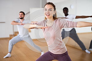 Young woman learning dynamic dances in choreography class