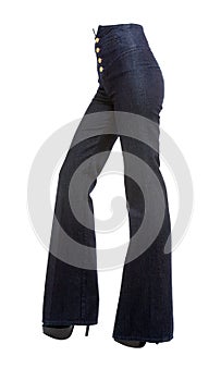 Young woman legs with bell bottom jeans and platform stilettos