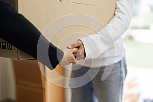 Young woman lesbian couple moving box together at new home. Homosexual-LGBTQ concept