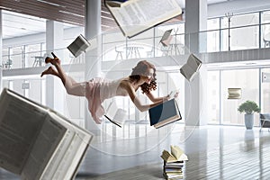 Young woman levitates while reading a book