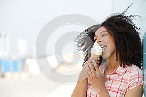 Young woman licking ice cream