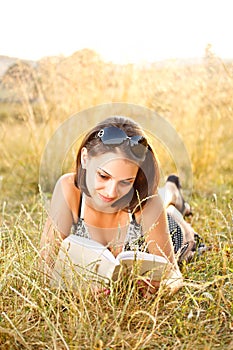 Young woman lies on grass