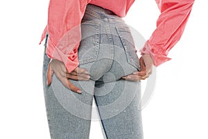 Young woman lift her buttocks with her hands