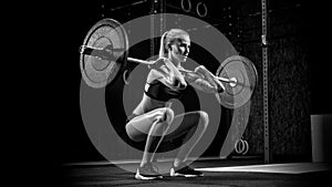 Young woman lifting heavy weights