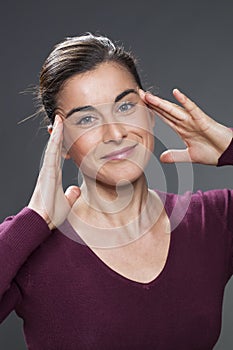 Young woman lifting her eyes for skin rejuvenation