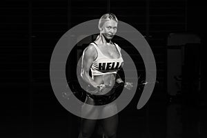 Young Woman Lifting Weights With Barbell