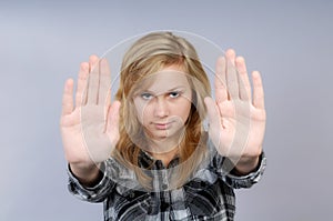 Young woman lifts hands in defense