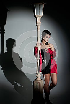 Young woman and lightpole