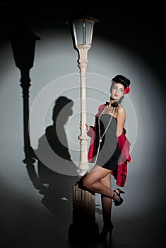Young woman and lightpole