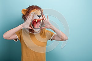 Young woman in lion mask holding hands near her open mouth, making loud announcement