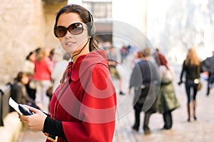 Young woman listening to audio guide