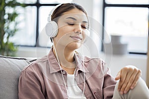 Young woman is listening to music