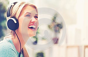 Young woman listening to music on headphones