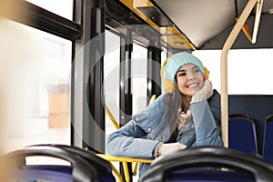 Young woman listening to music with headphones in public