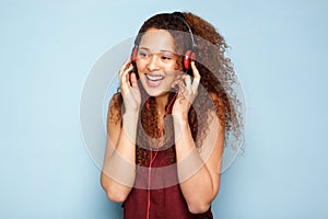 Young woman listening to music with headphones and smiling