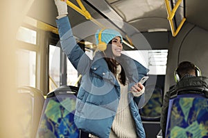 Young woman listening to music with headphones in transport