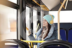 Young woman listening to music with headphones in transport