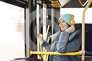 Young woman listening to music with headphones in transport