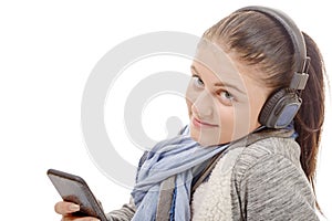 Young woman listening to music with his mobile phone and headph