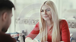 Young woman listens attentively to a man.