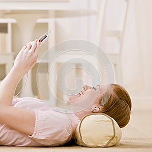 Young woman listens to music on mp3 player