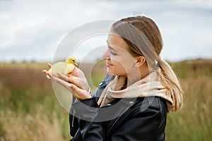 Young woman with little duckling