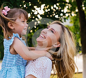 A young woman and a little girl are spinning and laughing.Joy and carelessness