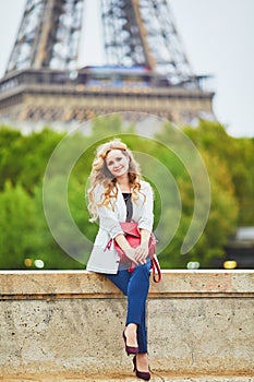 Young woman with long blond curly hair in Paris, France