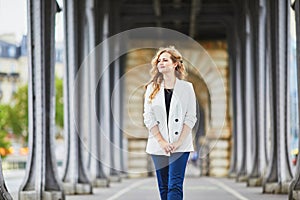 Young woman with long blond curly hair in Paris, France