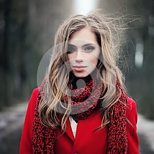 Young woman with long blowing hair outdoors