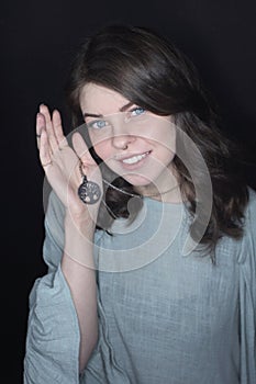 Young woman with long curly hair and green mascara