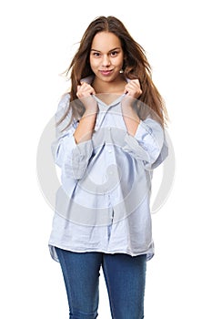 Young woman with long hair grinning and holding shirt