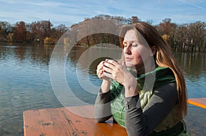 Mladá žena dlho vlasy pohár z čaj v ruky 