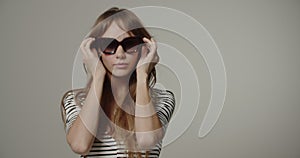 Young Woman With Long Hair Trying On Glasses