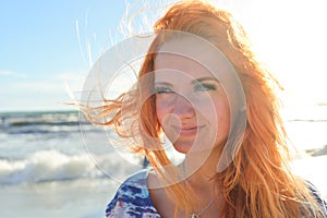 Young woman with long red hairs