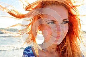 Young woman with long red hairs